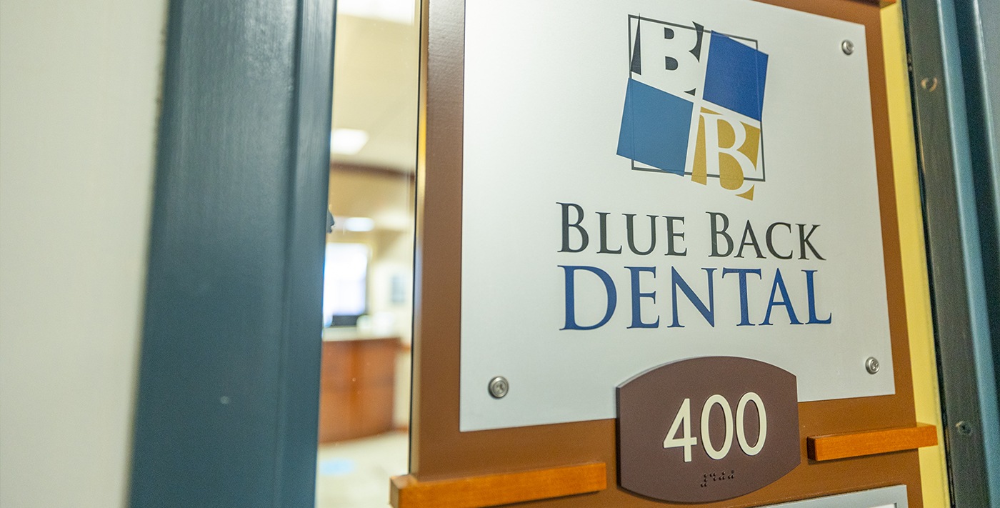 Blue Back Dental sign on outside of door of dental office in West Hartford and Avon