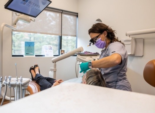 Dentist giving a patient an emergency dental exam