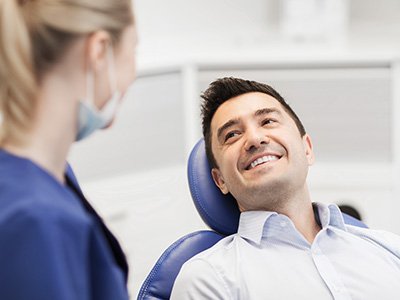 Patient smiling at dentist during exam