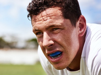 Closeup of man wearing blue mouthguard