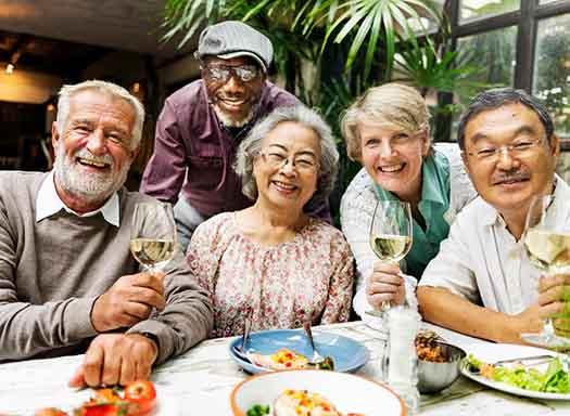 Patient in West Hartford smiling with friends in dentures